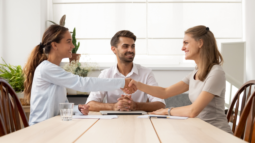 an image of business partners agreeing on a settlement with the help of a mediator